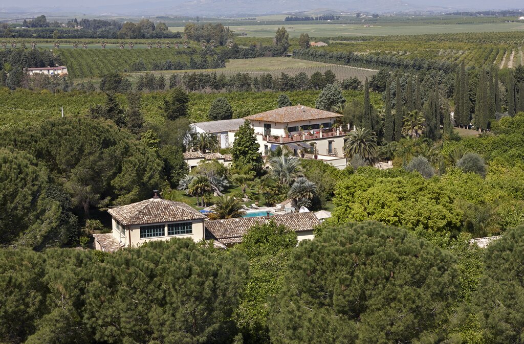 Orangerie building in the foreground, main house with bedrooms located in gardens on the far side of swimming pool