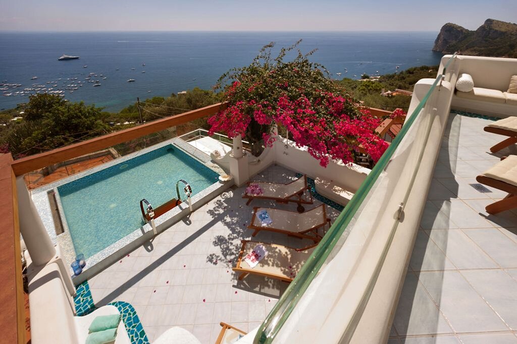 View of first floor exterior pool and sea from second floor master terrace