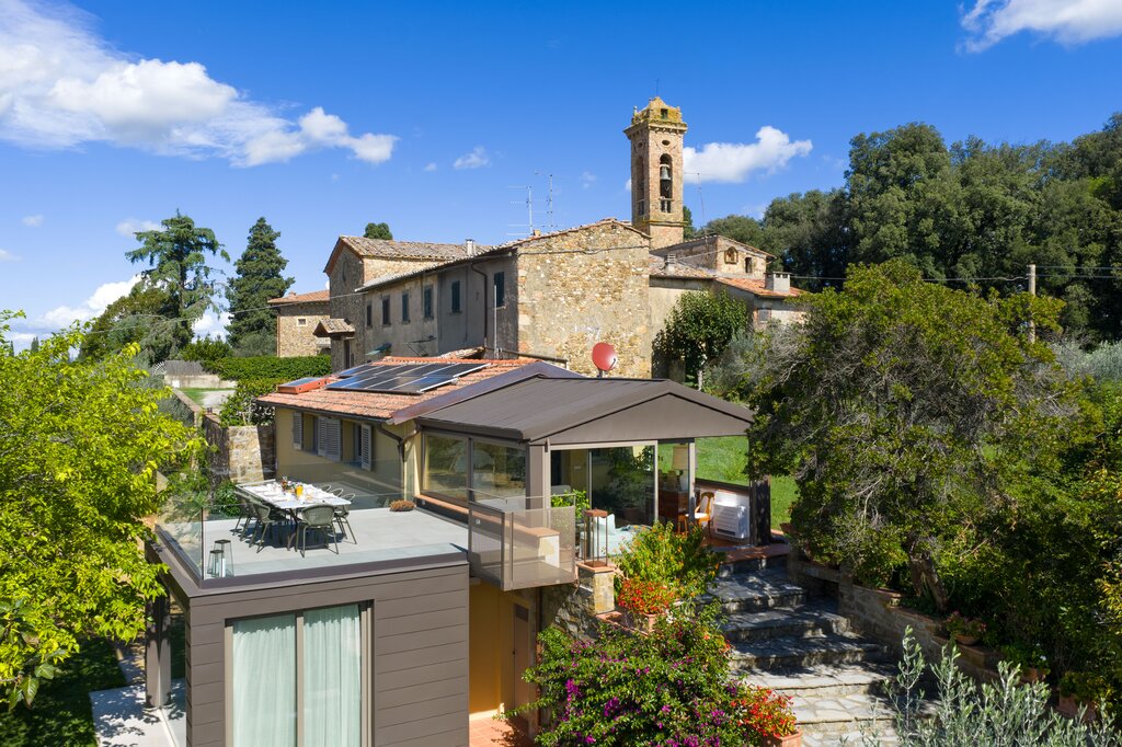 The villa set in the hamlet wit the church behind 